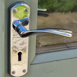 Chrome handle fitted to wooden door scaled